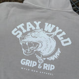 A gray hoodie with the 'STAY WYLD' logo and text 'GRIP & RIP' on the back, featuring a stylized dog head.